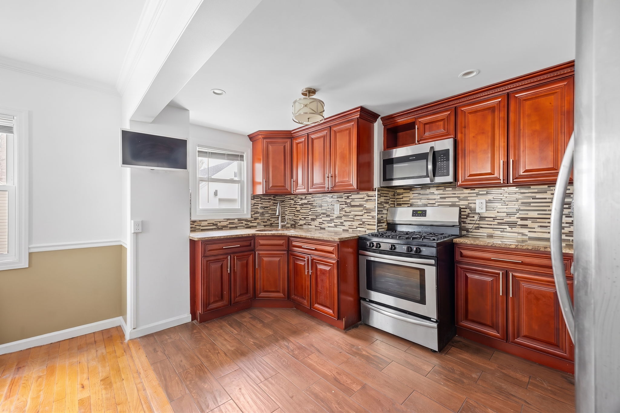 194-35 114th Drive Queens, NY 11412 - Photo 6 of 21 a kitchen with stainless steel appliances granite countertop a stove a sink dishwasher and a refrigerator