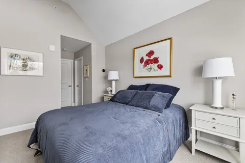 a bedroom with a bed and a painting on the wall