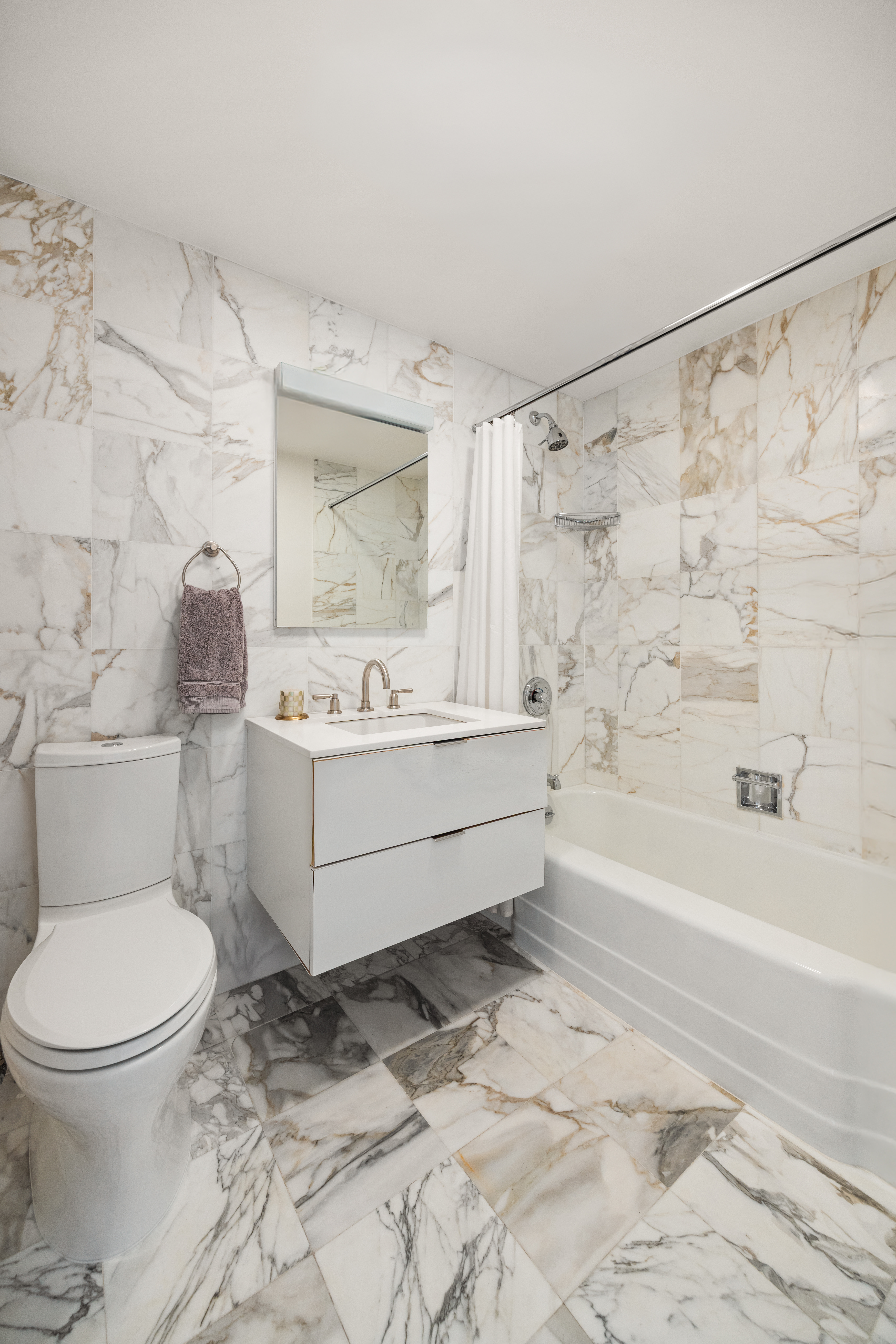 860 United Nations Plaza, Unit 16G Manhattan, NY 10017 - Photo 10 of 12 a bathroom with a sink toilet and bathtub