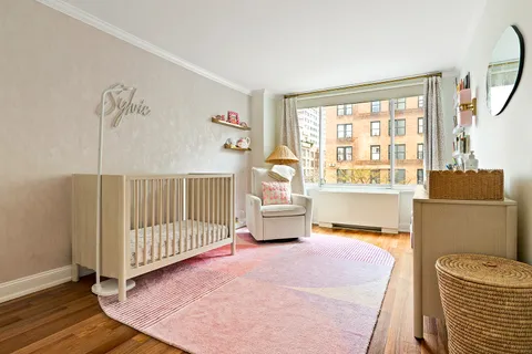 a bedroom with furniture and a large window