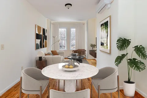 a view of a dining room with furniture and window