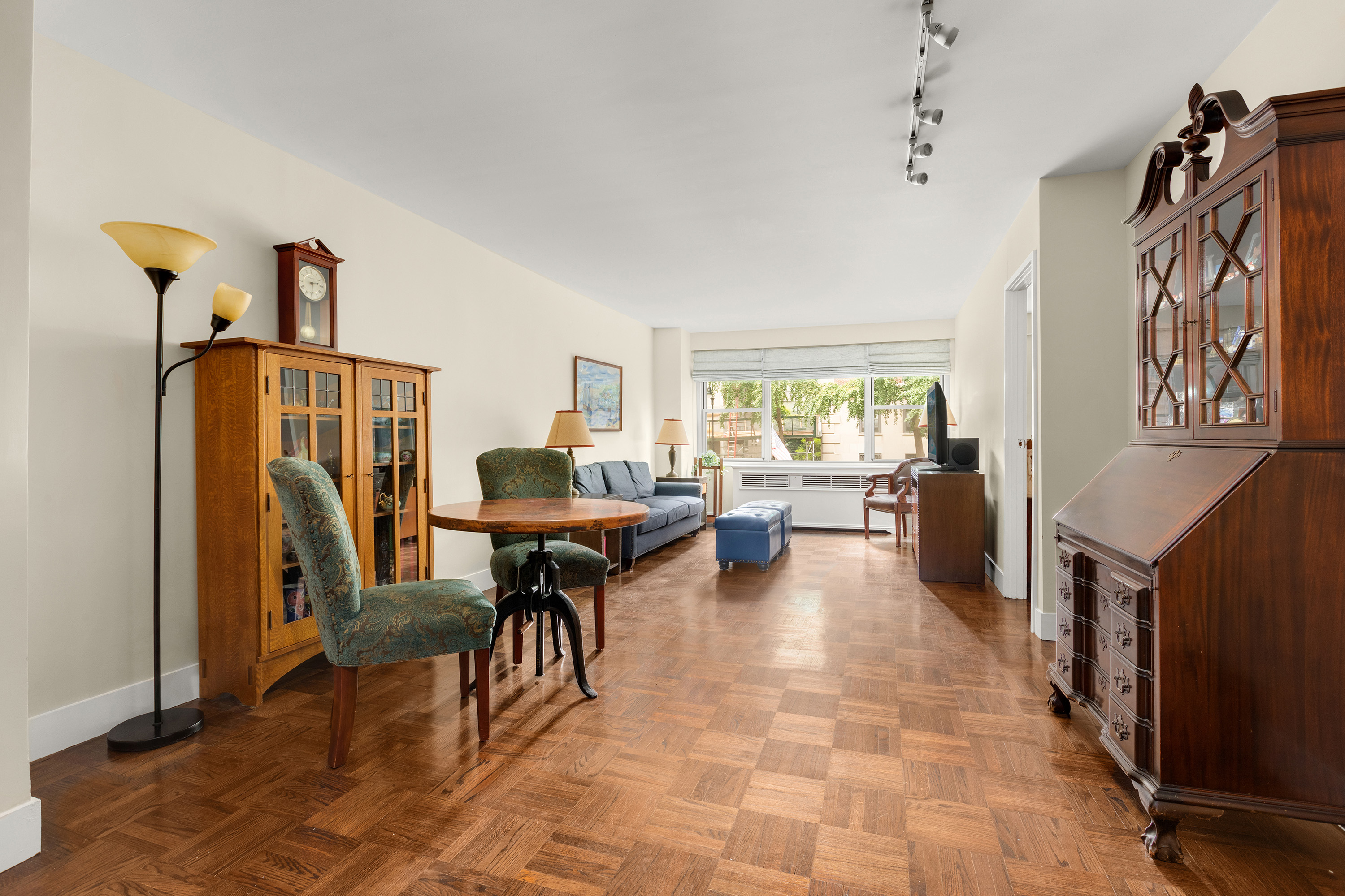 a living room with furniture a rug entryway and a window