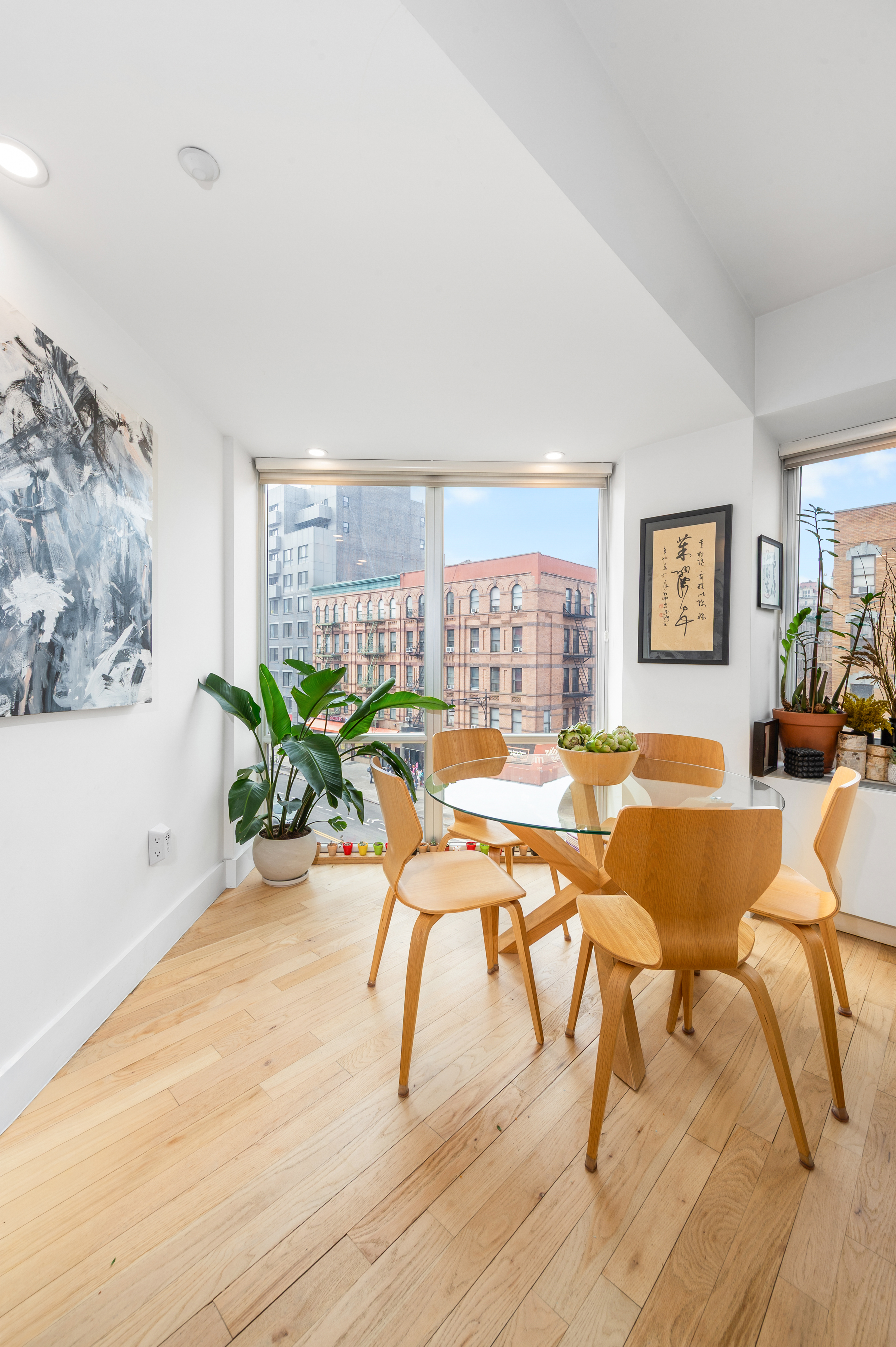 2110 Frederick Douglass Boulevard, Unit 4C Manhattan, NY 10026 - Photo 5 of 19 a living room with patio furniture and a potted plant