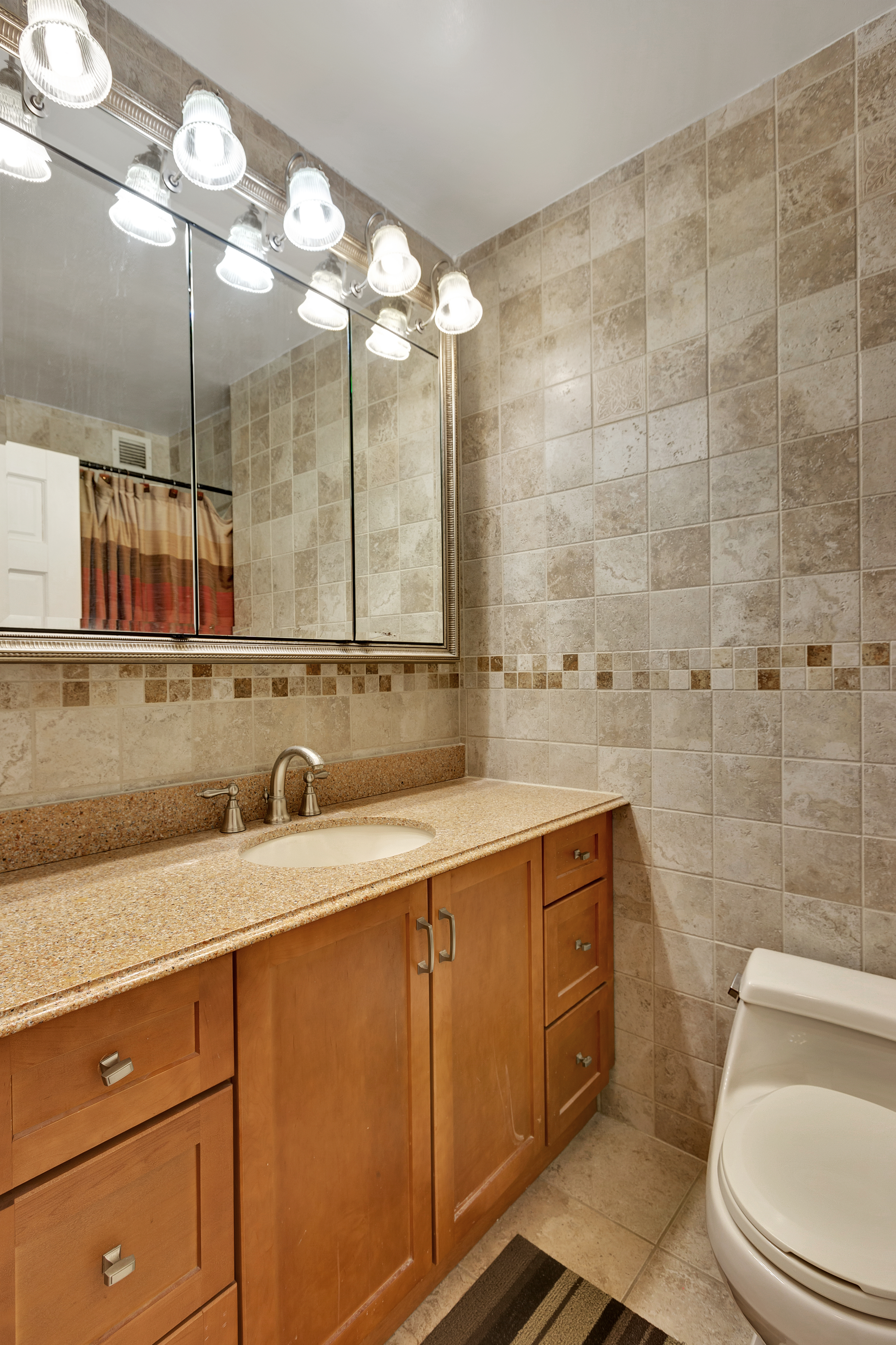 280 Park Avenue South, Unit 4D Manhattan, NY 10010 - Photo 5 of 13 a bathroom with a sink a toilet and a mirror