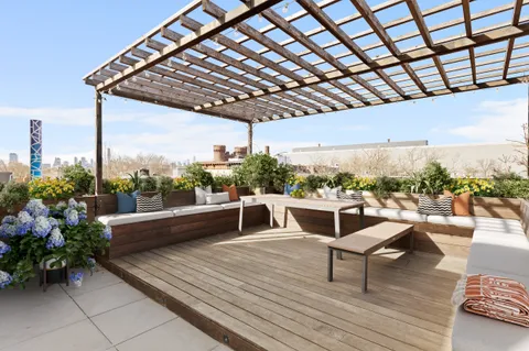 a roof deck with table and chairs