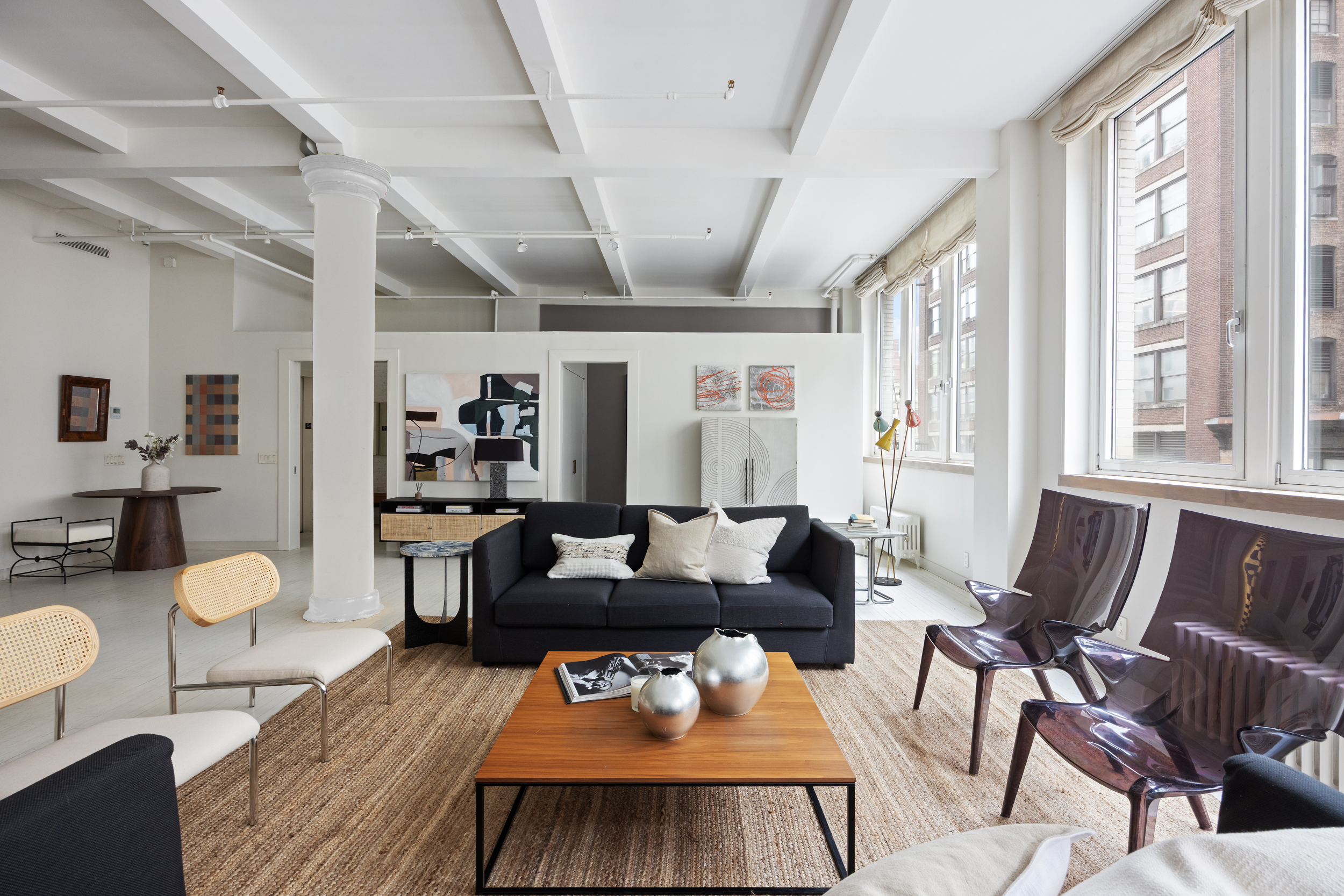32 West 20th Street, Unit 5 Manhattan, NY 10011 - Photo 3 of 18 a living room with furniture and a large window