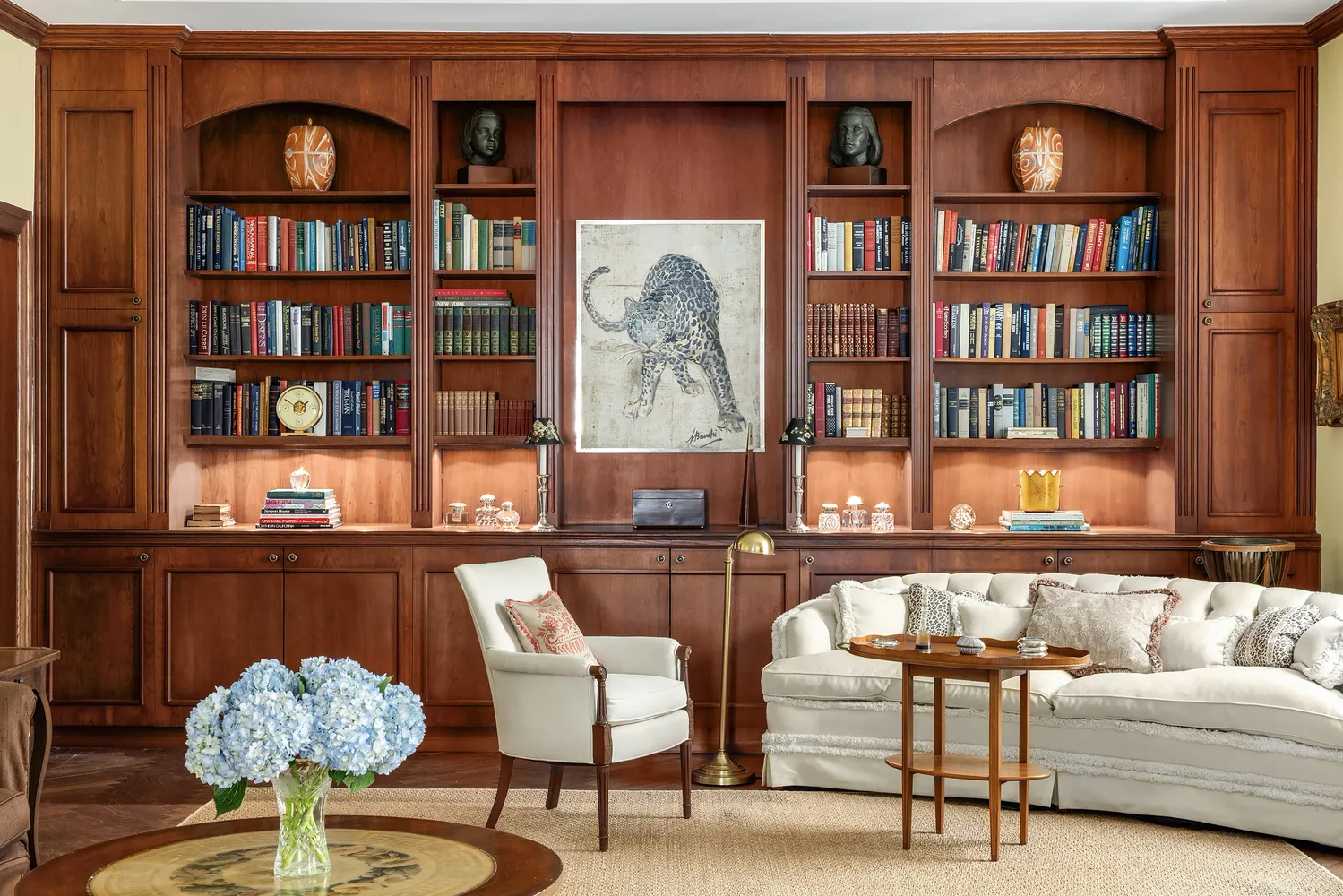 a living room with furniture and book shelf