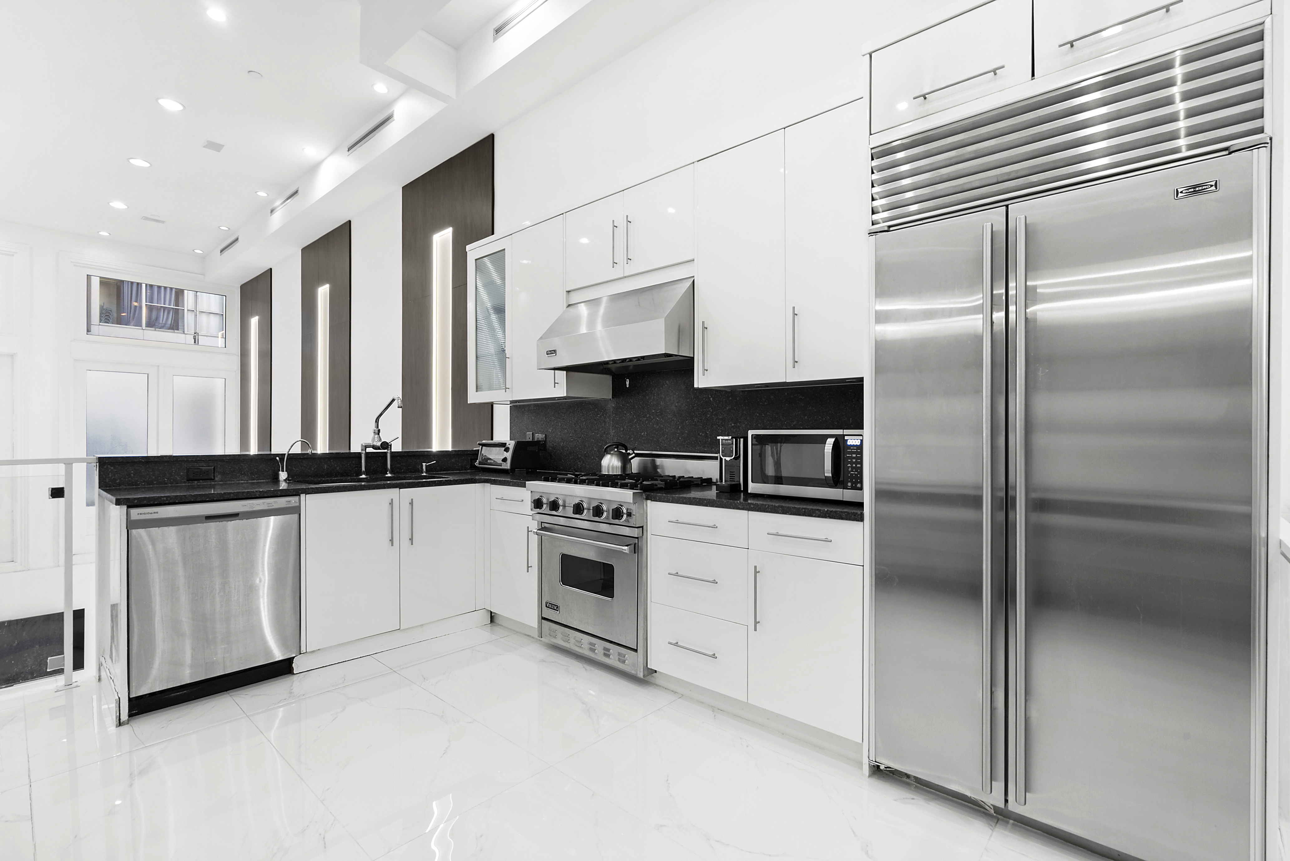 53 Murray Street, Unit 1 Manhattan, NY 10007 - Photo 5 of 12 a kitchen with stainless steel appliances granite countertop a refrigerator a stove and a sink