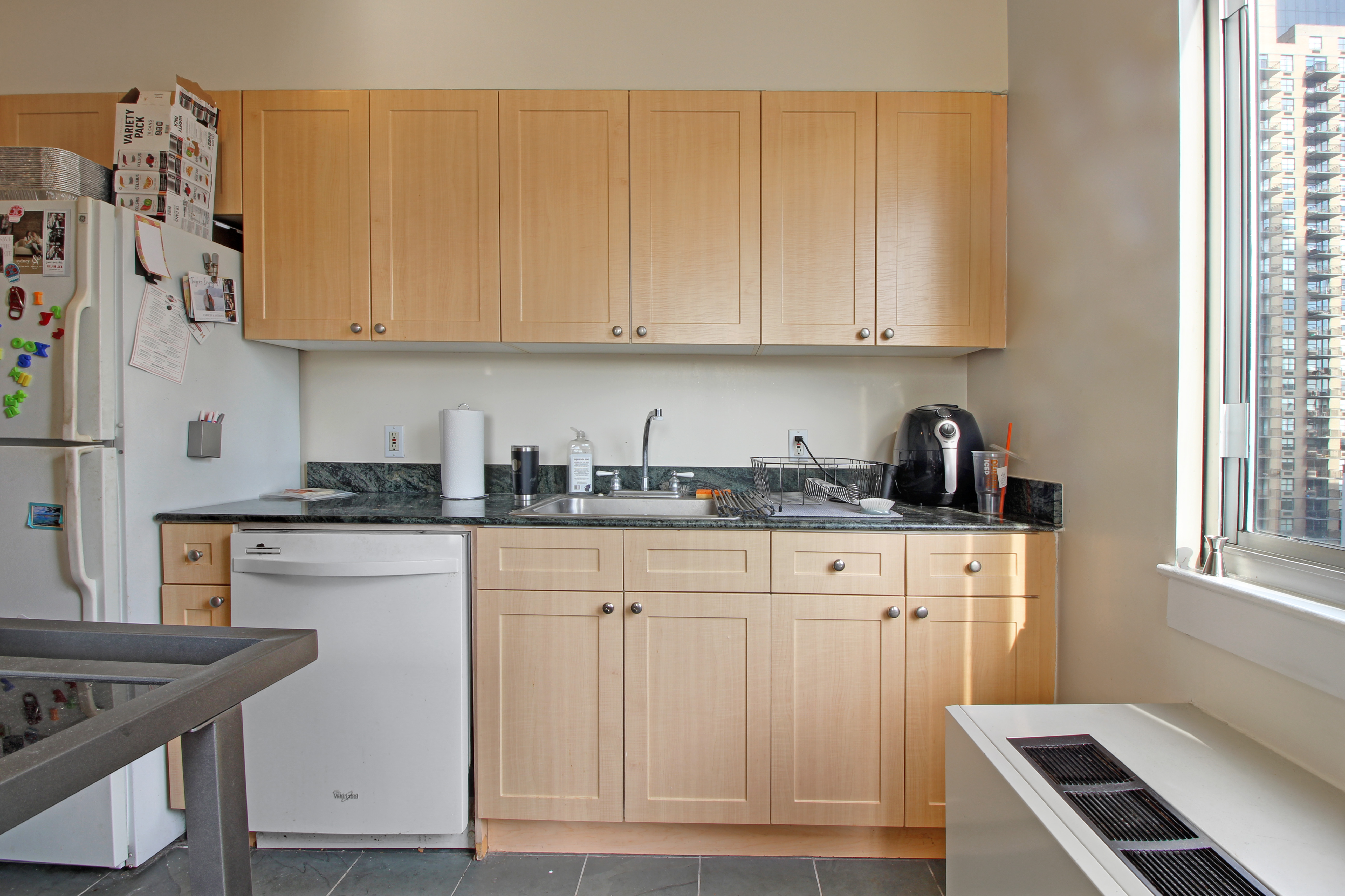 308 East 38th Street, Unit 20A Manhattan, NY 10016 - Photo 5 of 13 a kitchen with stainless steel appliances granite countertop a sink stove and cabinets