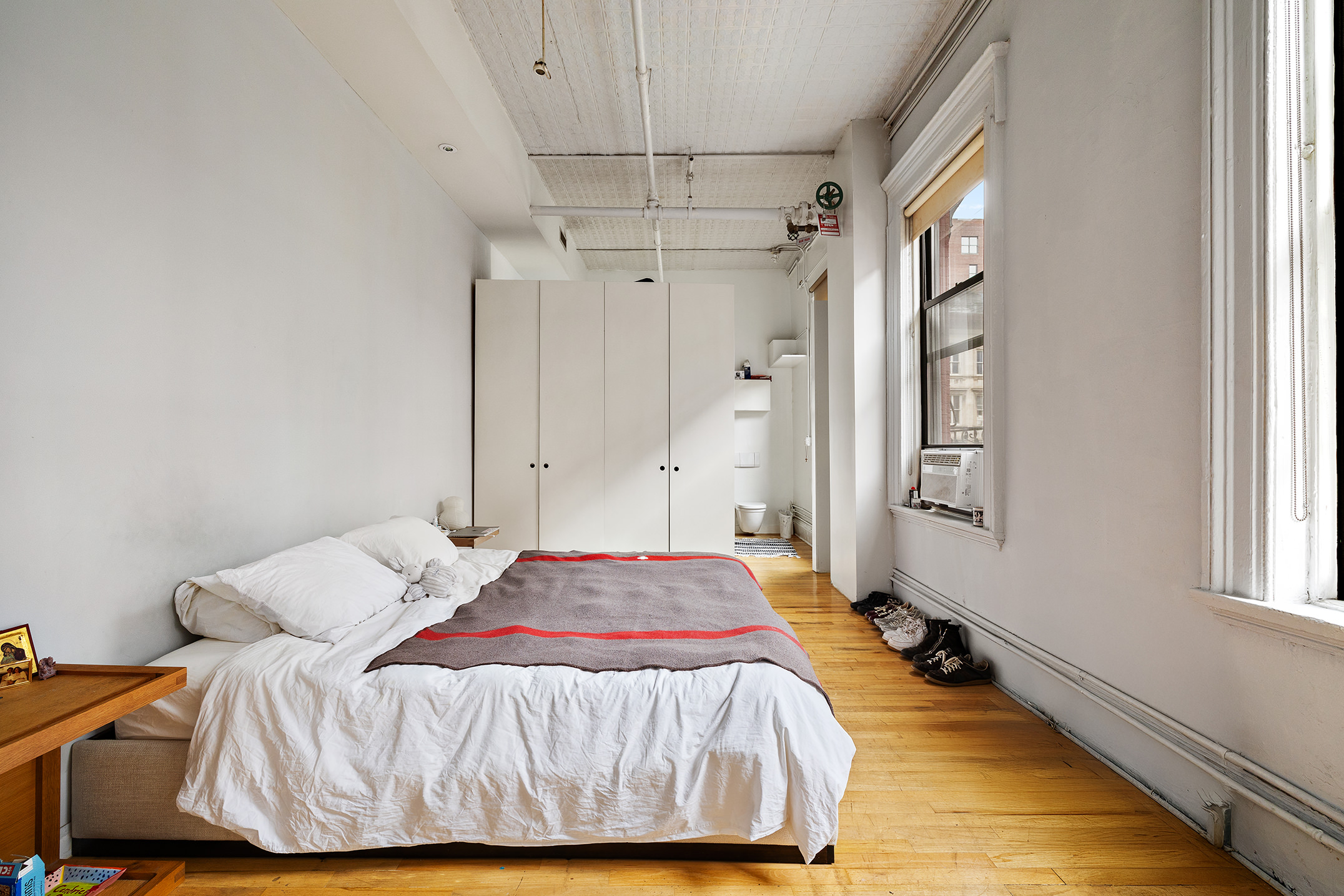 39 1/2 Crosby Street, Unit 4 Manhattan, NY 10012 - Photo 4 of 8 a bedroom with a bed and a window