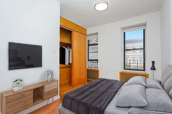 293 7th Avenue, Unit 3 Brooklyn, NY 11215 - Photo 7 of 9 a bedroom with a bed and a flat screen tv