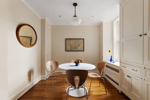 a dining room with furniture and a mirror