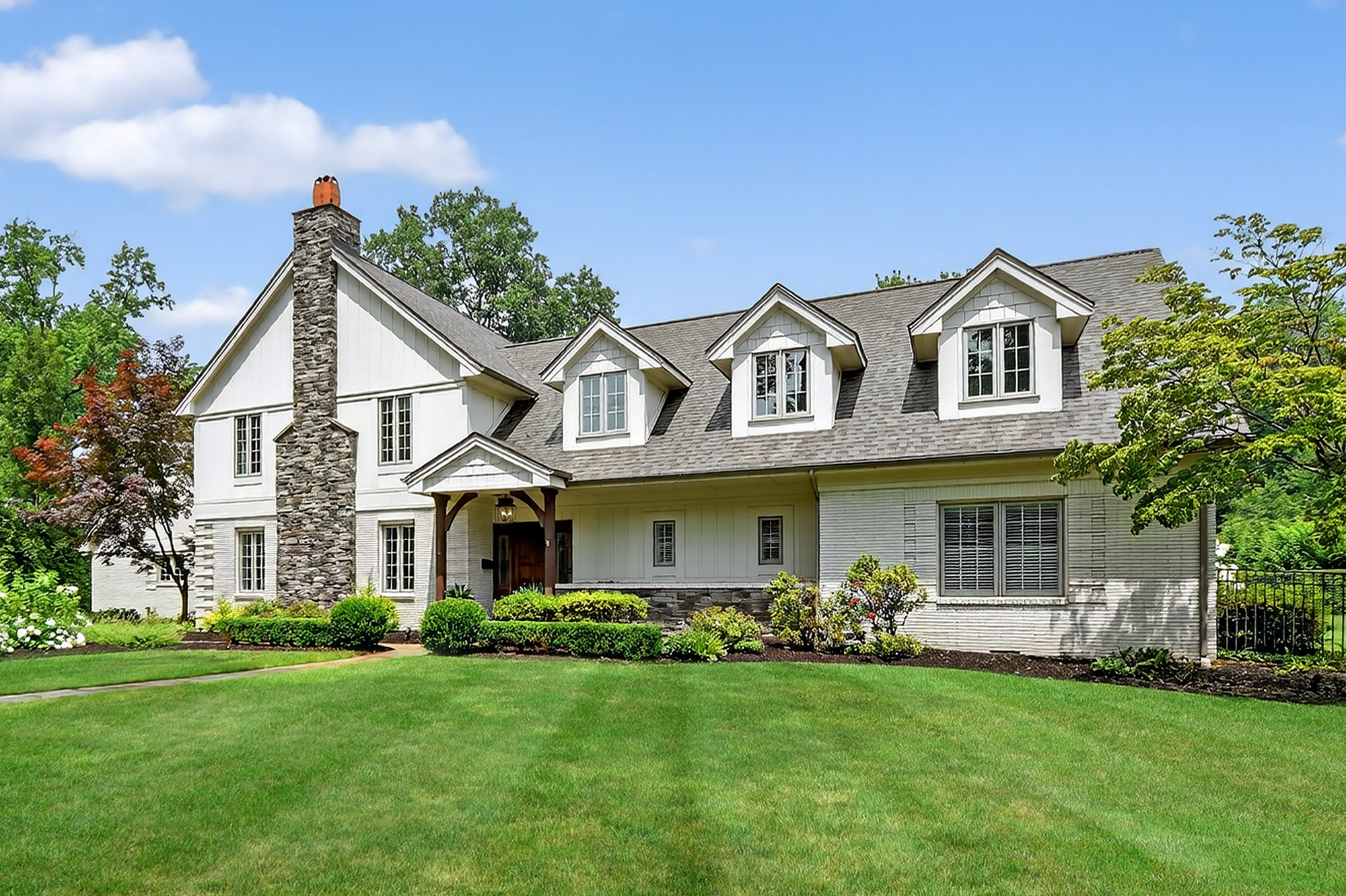 1205 Beaver Road Sewickley, PA 15143 - Photo 2 of 94 a front view of a house with a garden and plants