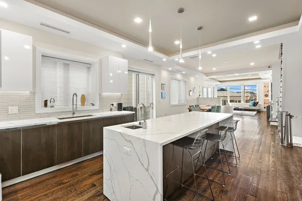 a large kitchen with a large counter top appliances and cabinets