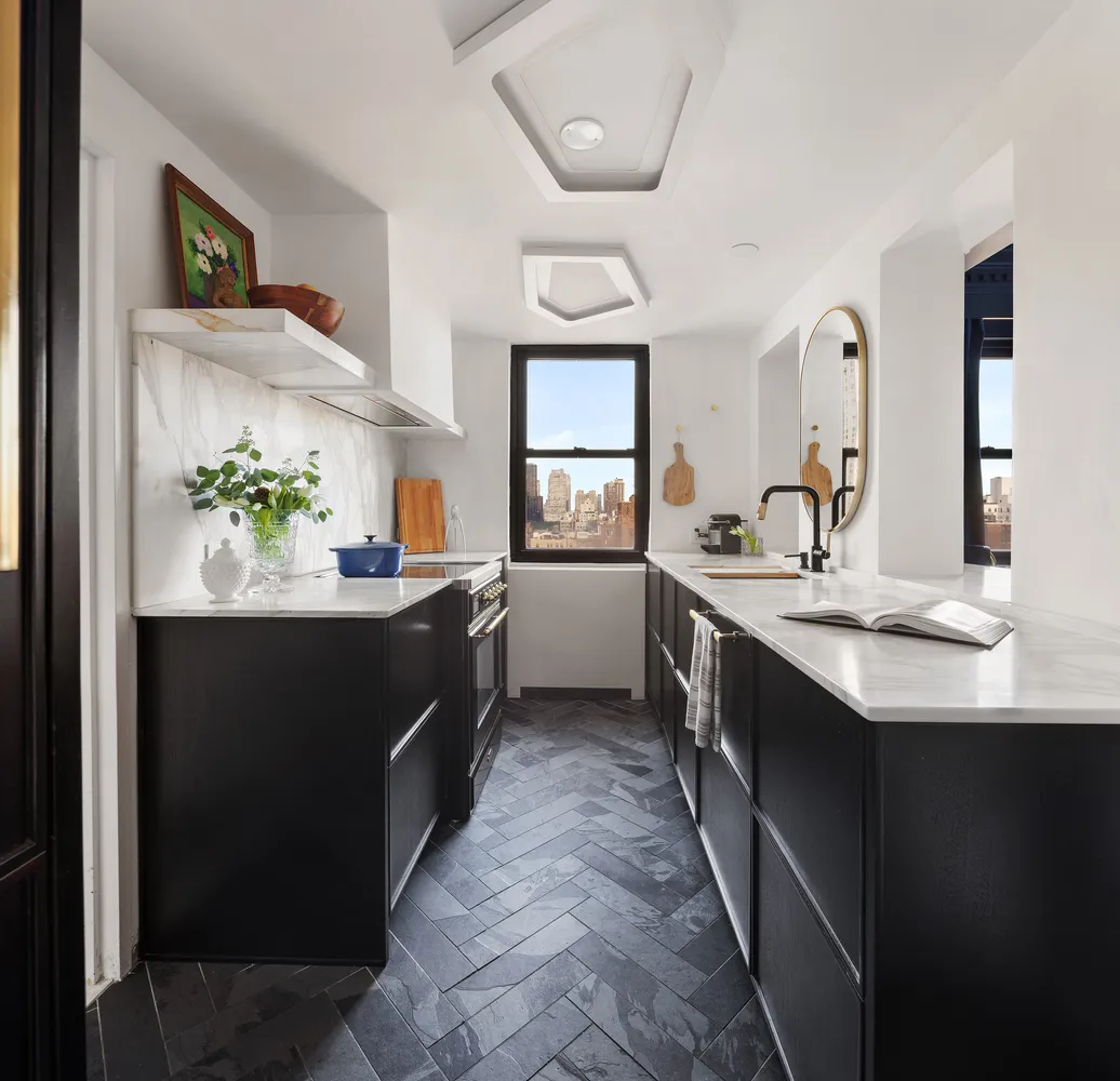 a kitchen with a sink and stove top oven