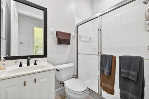 a bathroom with a sink toilet and shower