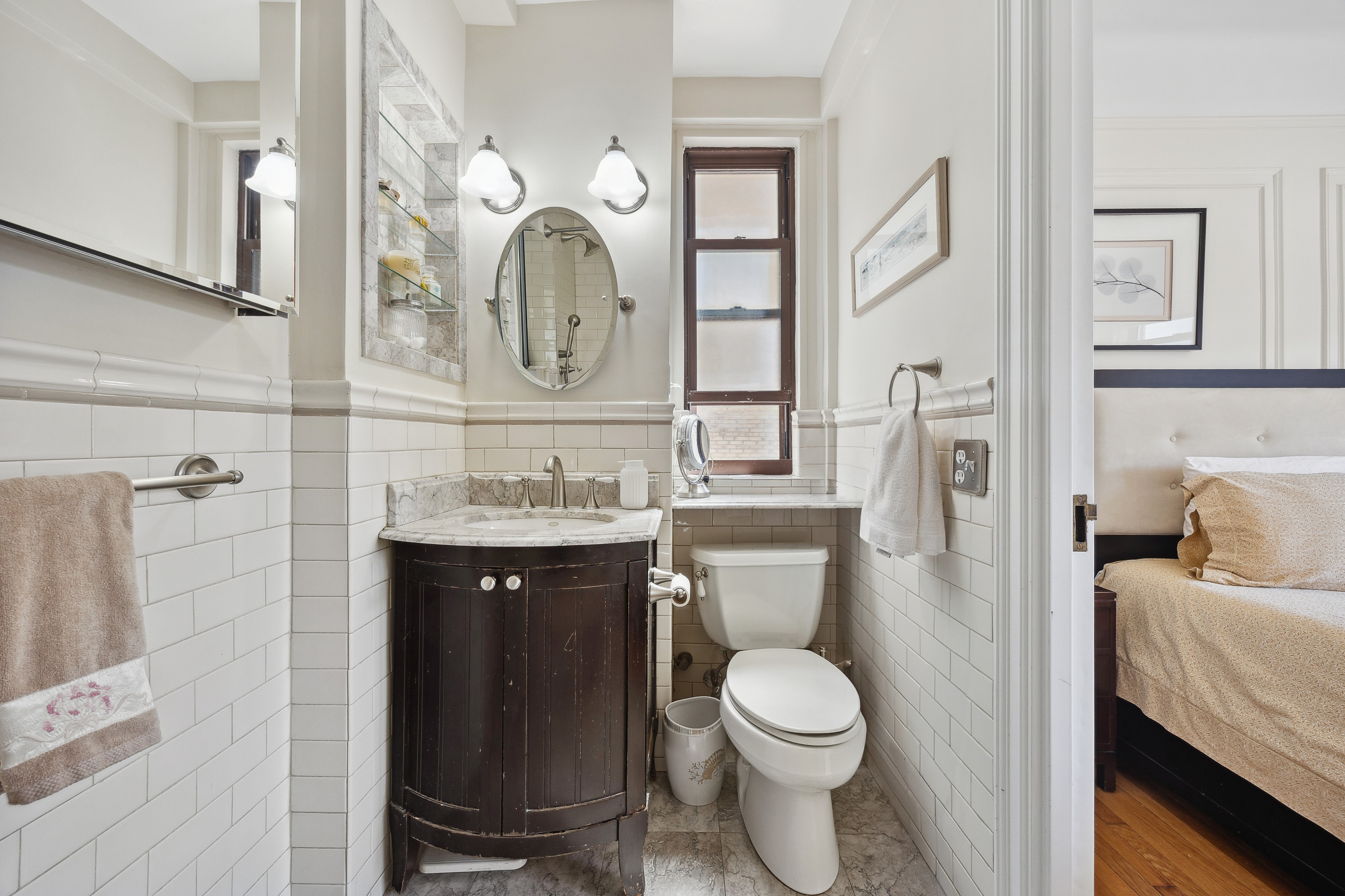 40 West 77th Street, Unit 8C Manhattan, NY 10024 - Photo 13 of 21 a bathroom with a toilet a sink and a mirror