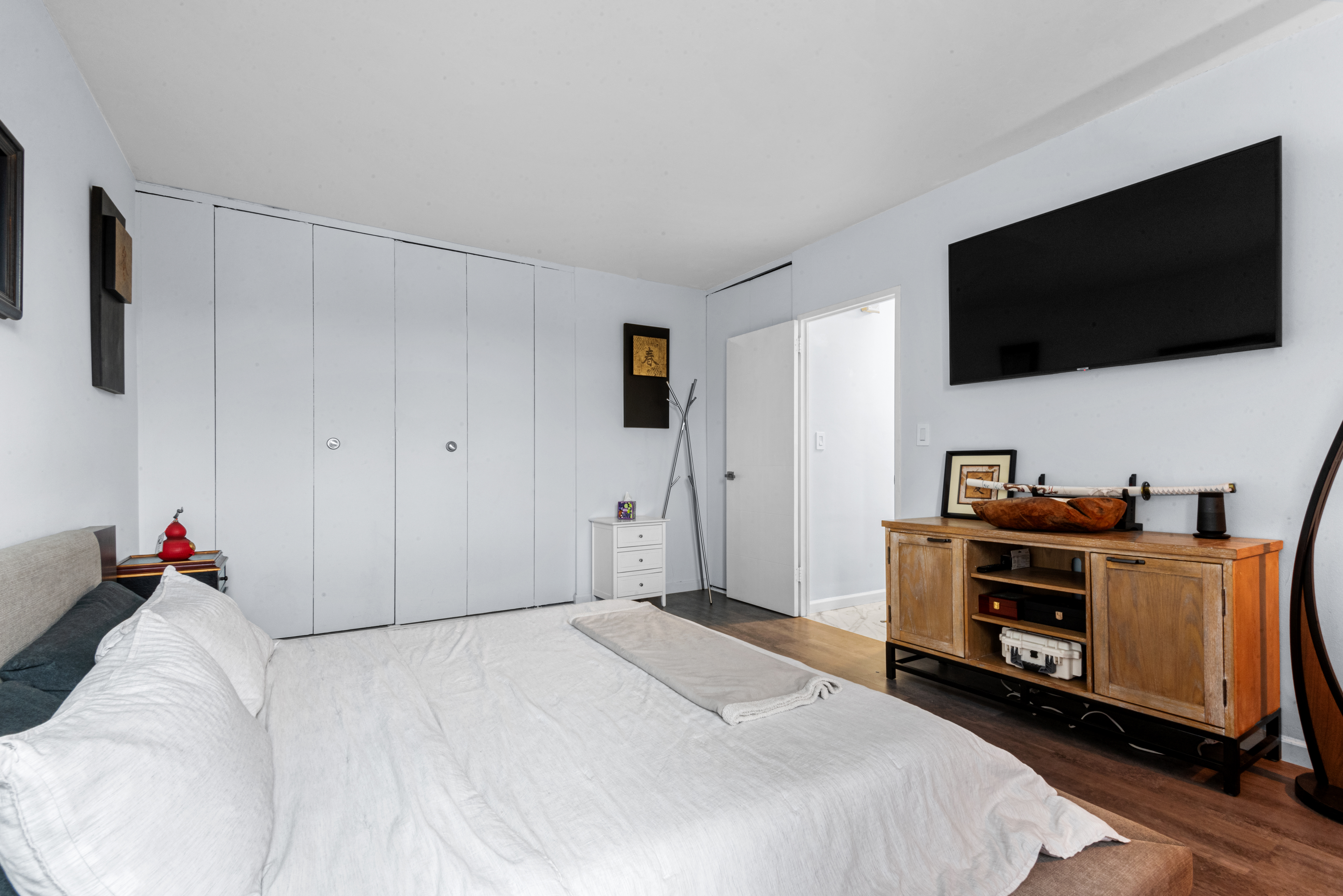 4 Horizon Road, Unit 1013 Fort Lee, NJ 07024 - Photo 13 of 18 a bedroom with a bed and a flat screen tv