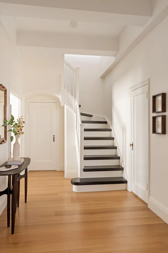 a view of entryway and hall with wooden floor