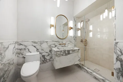 a bathroom with a toilet sink and shower