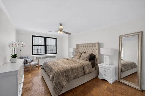 a bedroom with a large bed and a chandelier