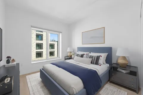 a bedroom with bed and window