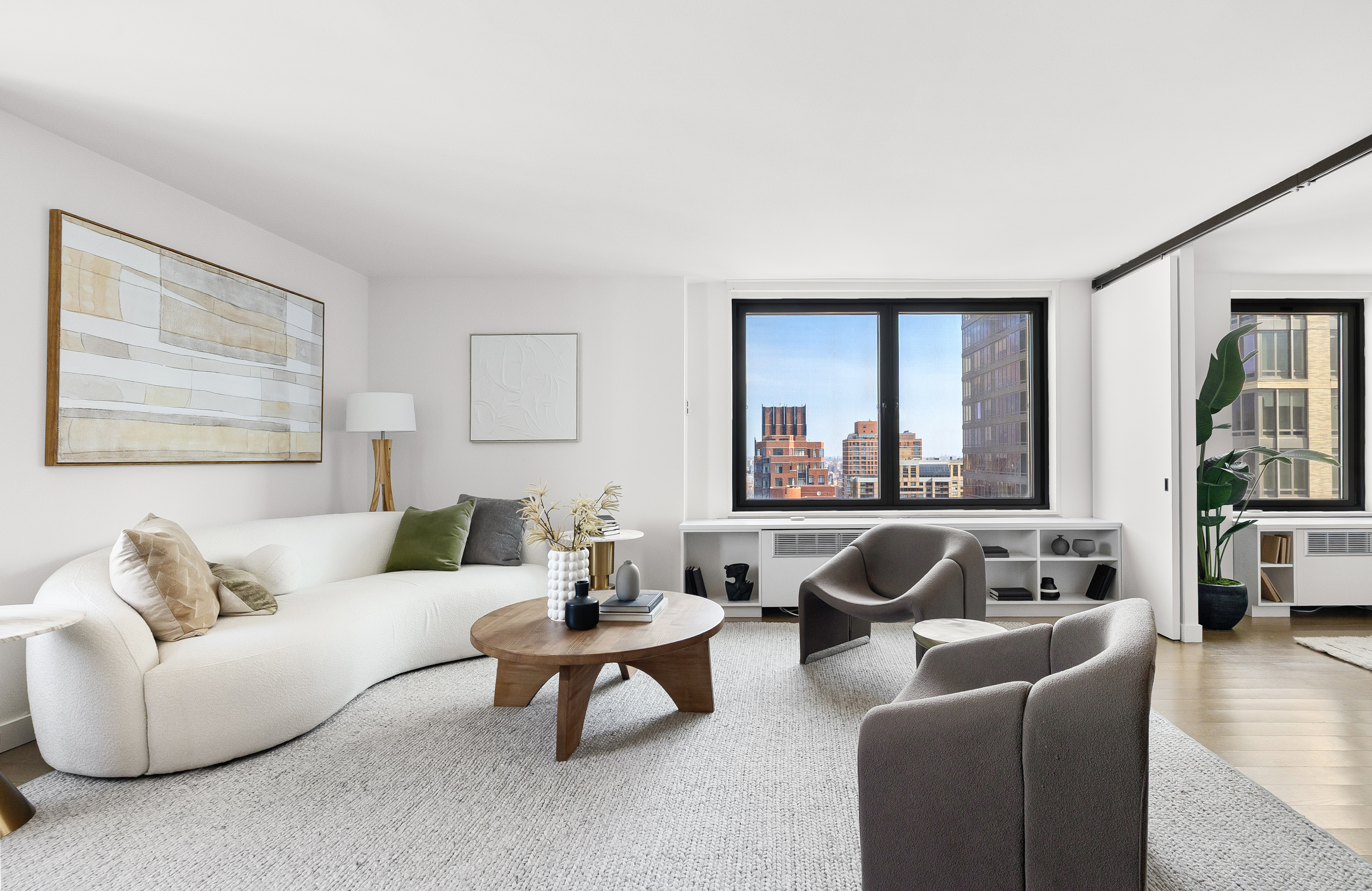 1623 3rd Avenue, Unit 36A Manhattan, NY 10128 - Photo 2 of 17 a living room with furniture and a large window