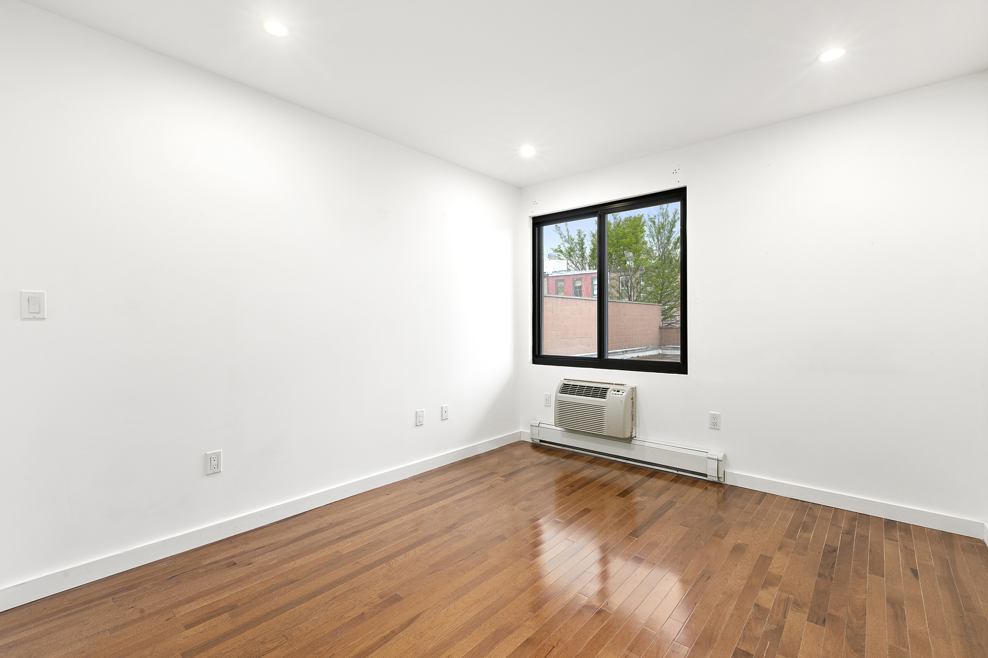 400 15th Street, Unit 2D Brooklyn, NY 11215 - Photo 7 of 8 an empty room with wooden floor and windows