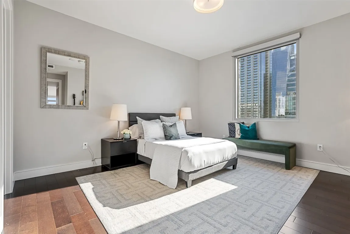 a bedroom with a large bed and a window