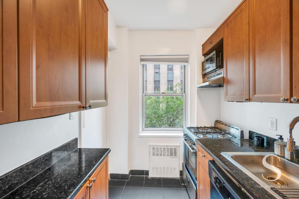 7 Lexington Avenue, Unit 5E Manhattan, NY 10010 - Photo 15 of 27 a kitchen that has a sink and a stove in it