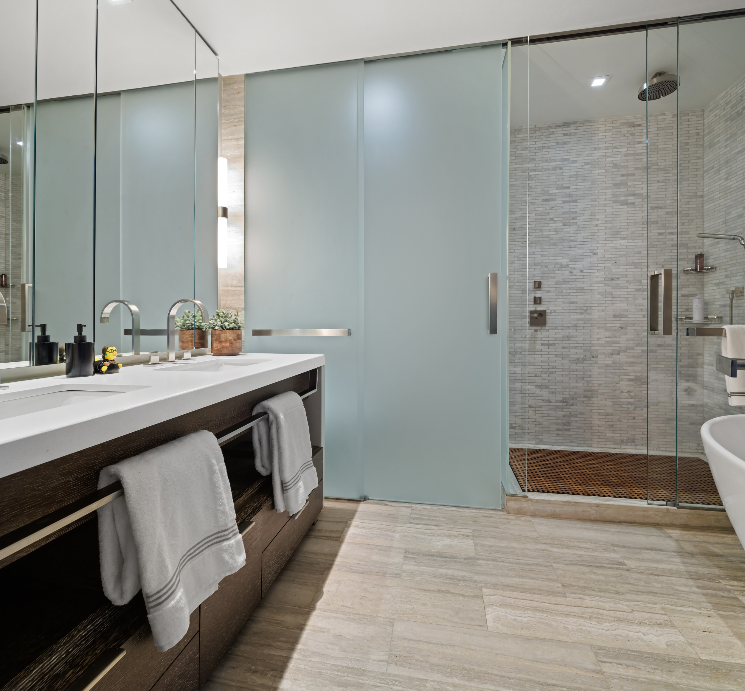 400 West 12th Street, Unit 4E Manhattan, NY 10014 - Photo 20 of 24 a bathroom with a double vanity sink a toilet and shower