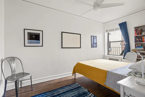 a bedroom with a bed and a chair