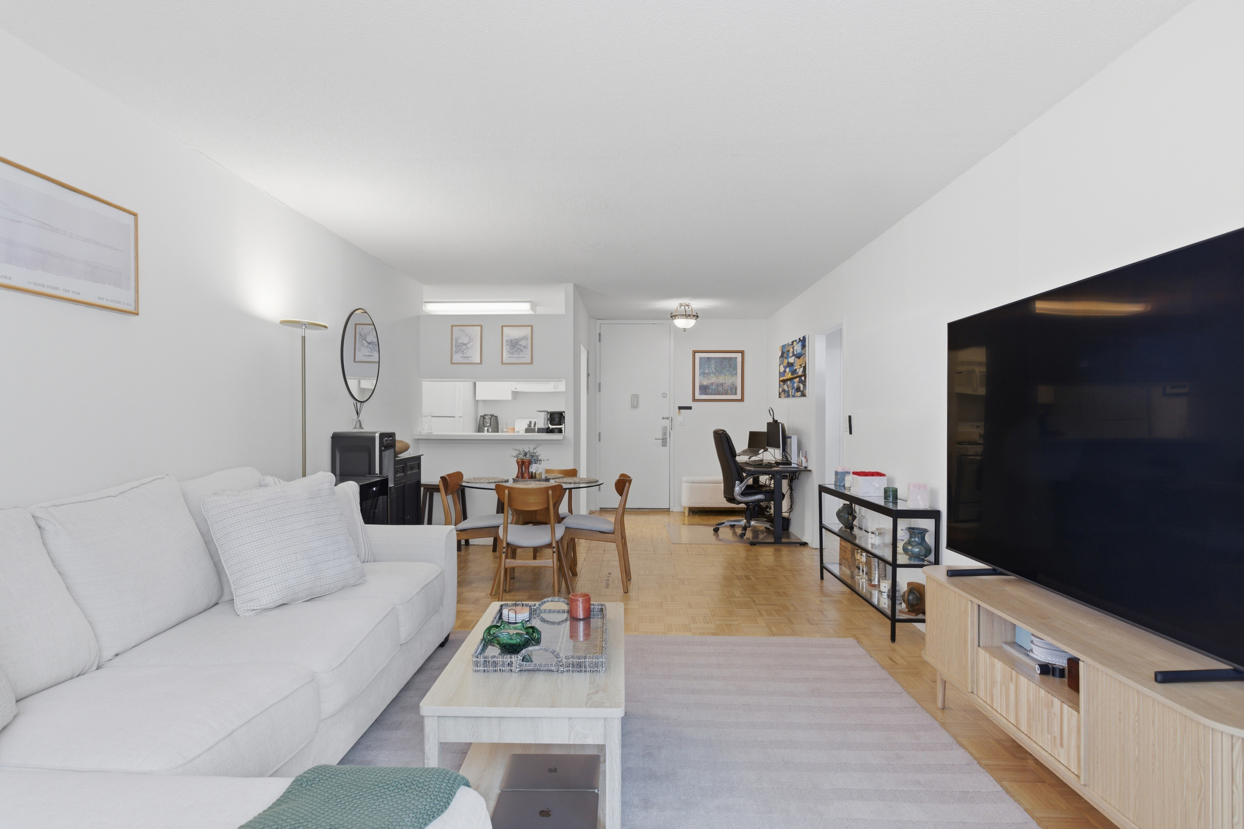 280 Park Avenue South, Unit 5L Manhattan, NY 10010 - Photo 3 of 17 a living room with furniture and a flat screen tv