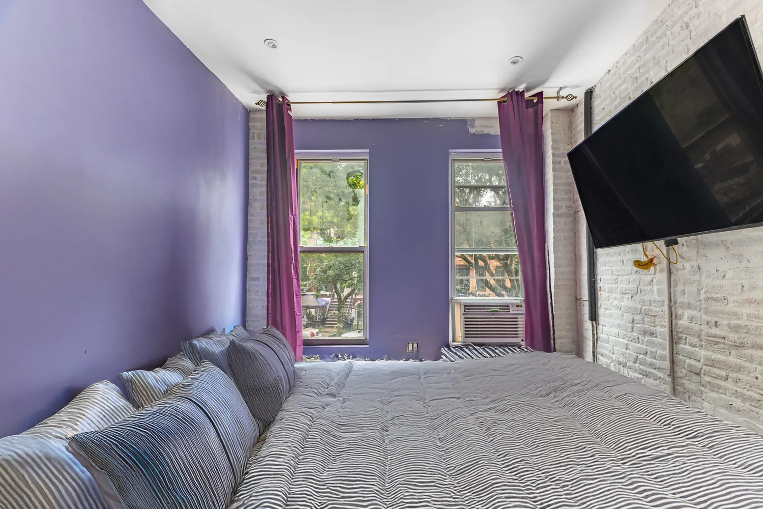 a bed room with a bed and a television