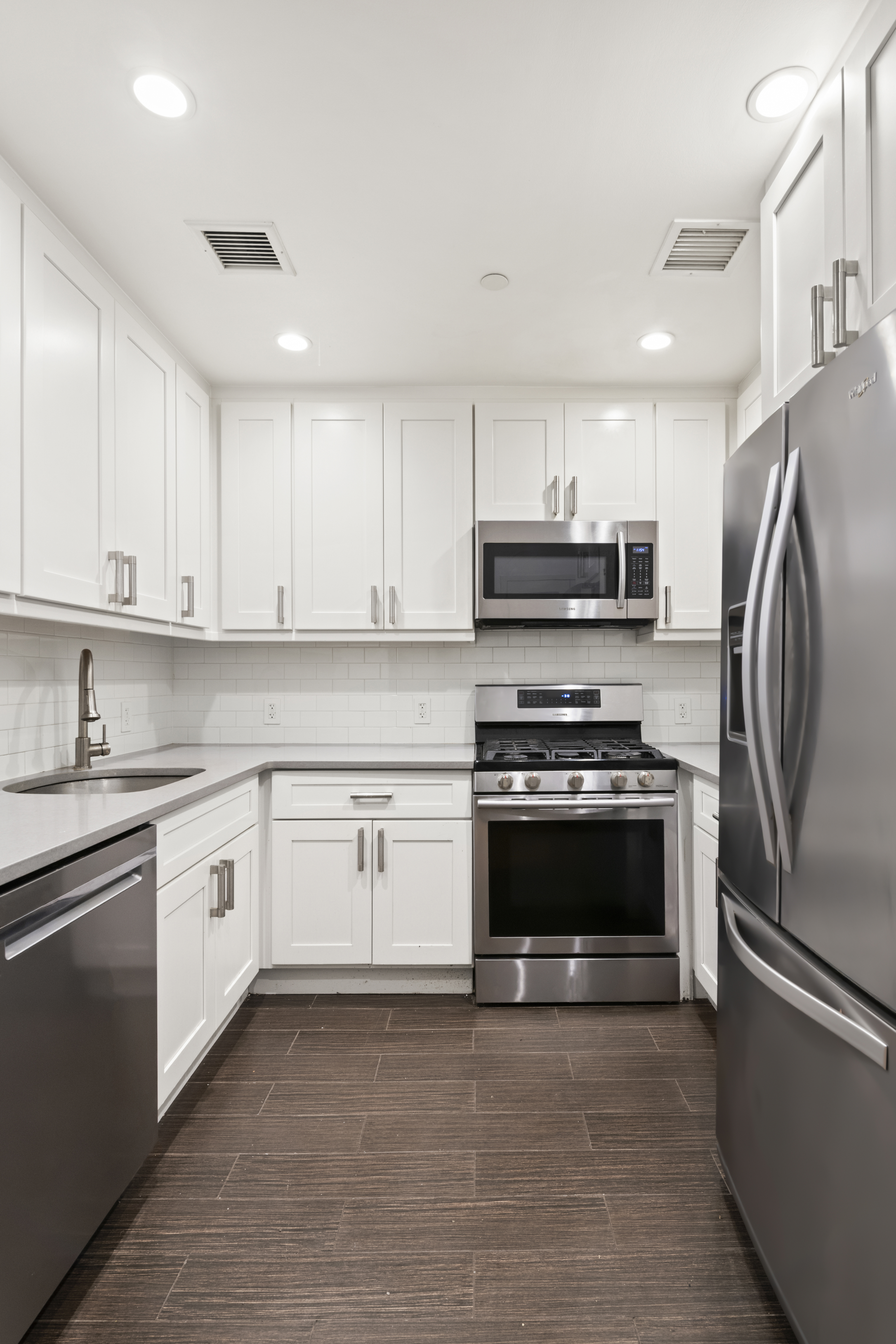 25 Lexington Avenue, Unit 103 Brooklyn, NY 11238 - Photo 6 of 15 a kitchen with granite countertop a refrigerator stove and sink