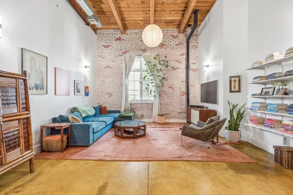 a living room with furniture a rug and a large window