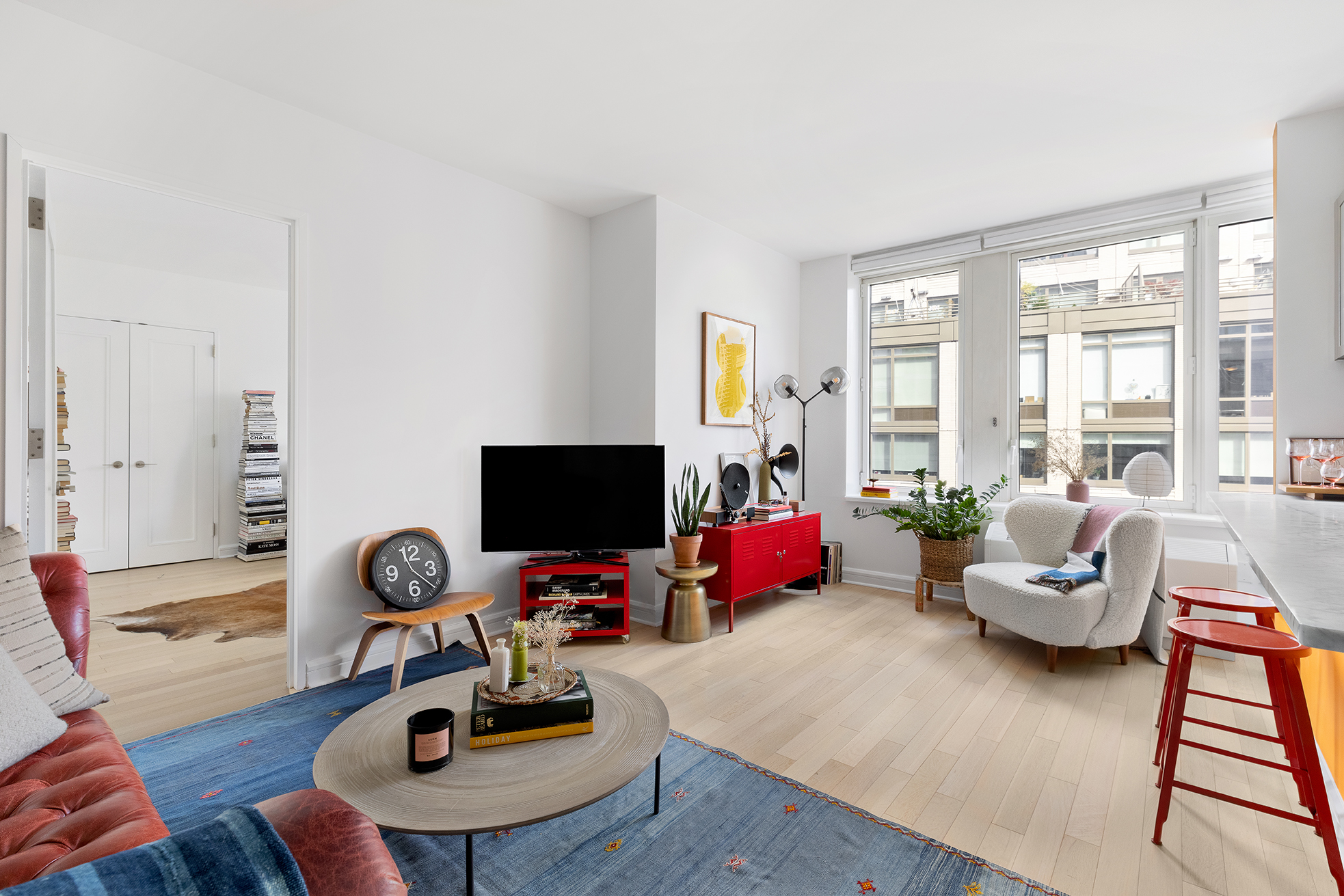 80 Riverside Boulevard, Unit 12D Manhattan, NY 10069 - Photo 1 of 16 a living room with furniture a flat screen tv and a large window