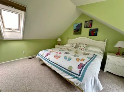 a bedroom with a bed and a table in it