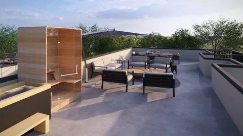 an outdoor sitting area with couch and wooden floor