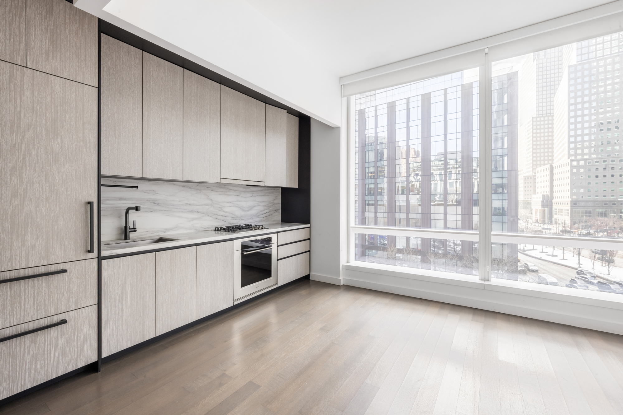 111 Murray Street, Unit 7D Manhattan, NY 10007 - Photo 4 of 17 a large white kitchen with granite countertop a large window and white cabinets