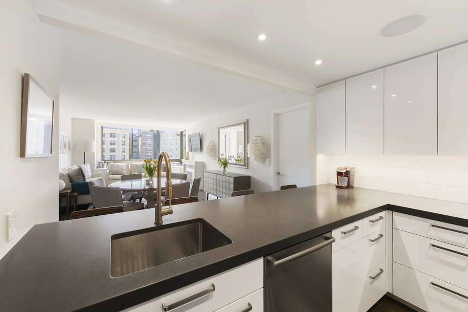 225 West 83rd Street, Unit 10K Manhattan, NY 10024 - Photo 6 of 21 a view of center kitchen island a sink a counter space and living room view