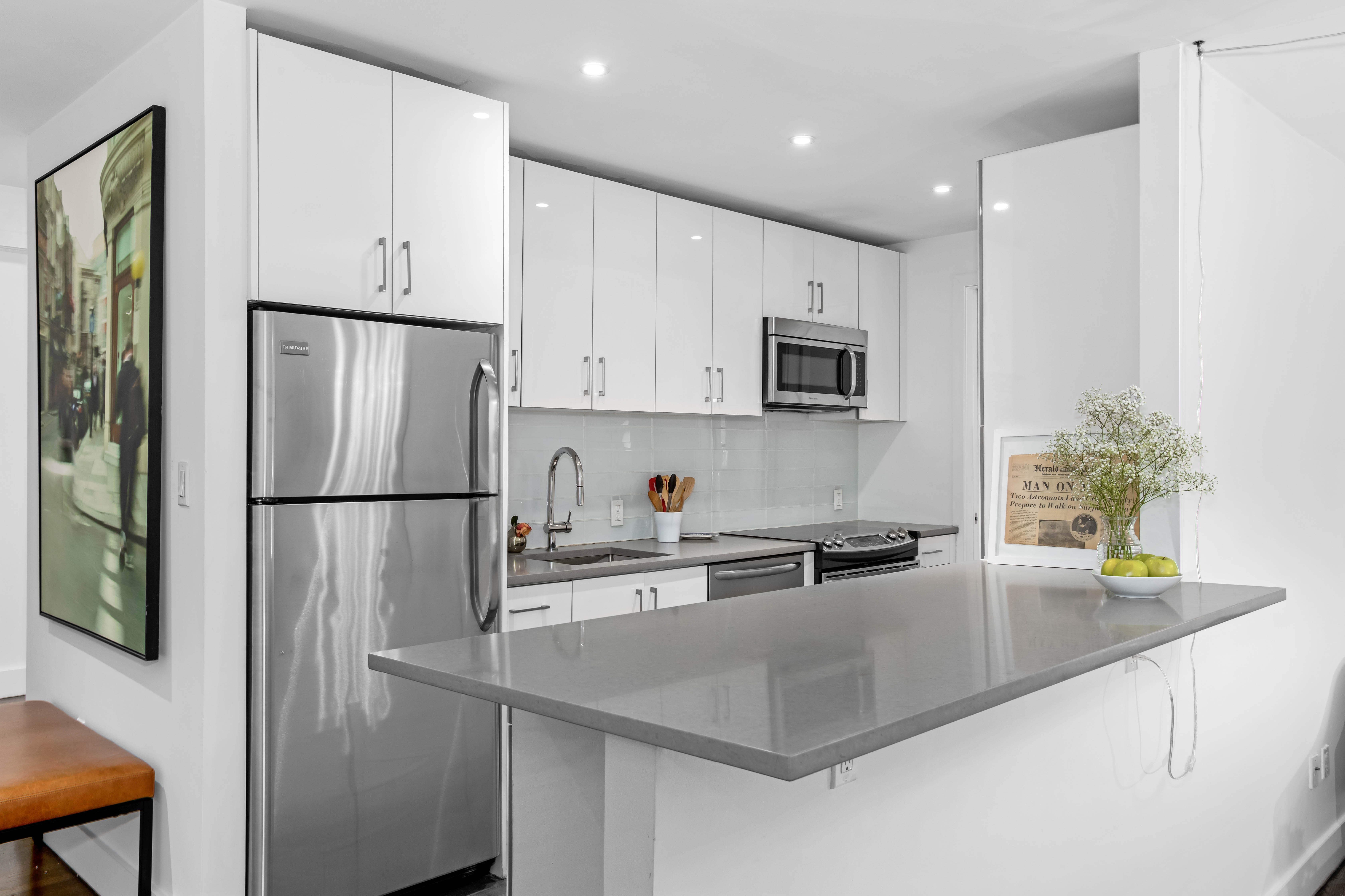 245 West 25th Street, Unit 3F Manhattan, NY 10001 - Photo 2 of 13 a kitchen with stainless steel appliances a refrigerator sink and microwave