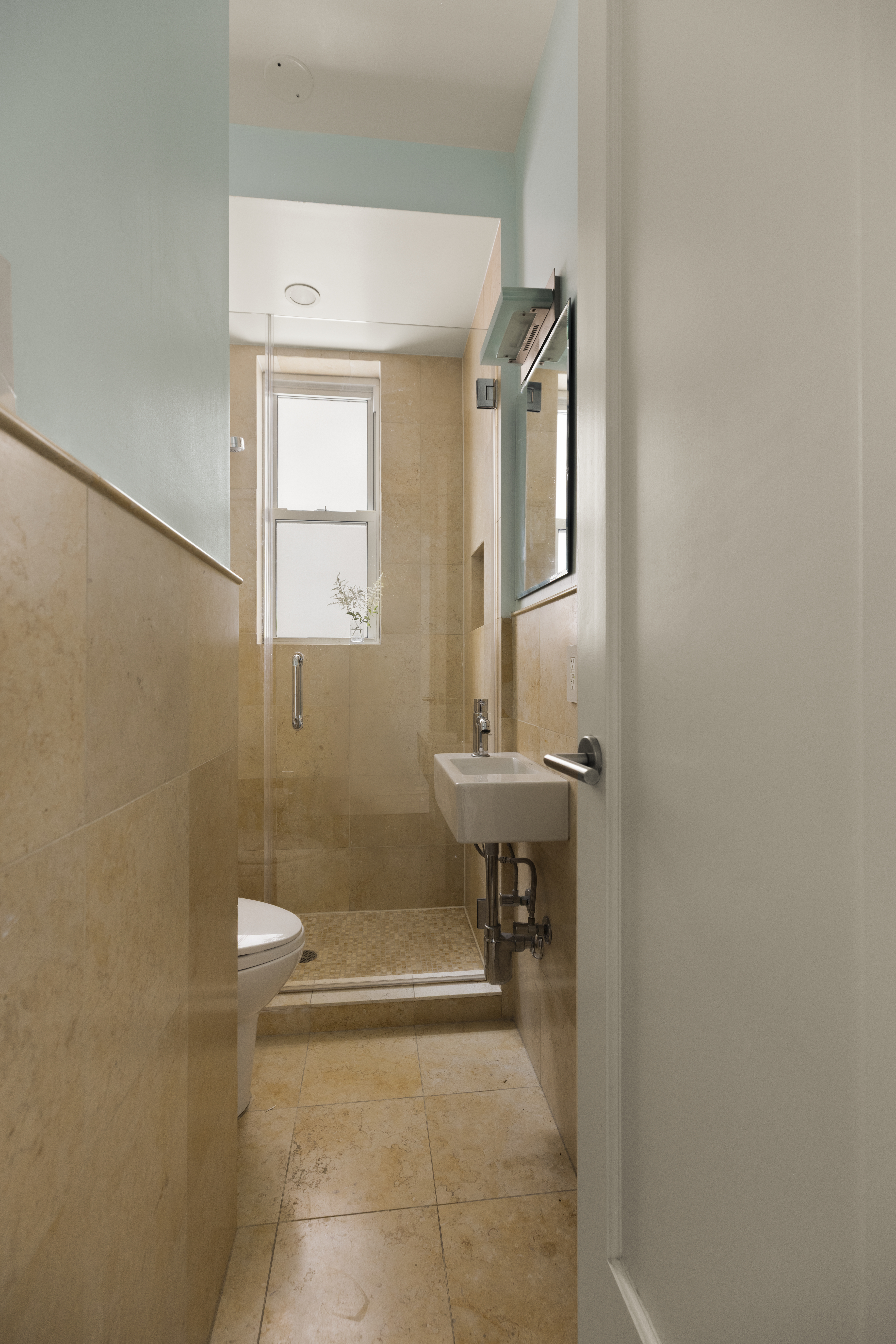 1158 5th Avenue, Unit 4A Manhattan, NY 10128 - Photo 15 of 23 a bathroom with a sink a toilet and a mirror