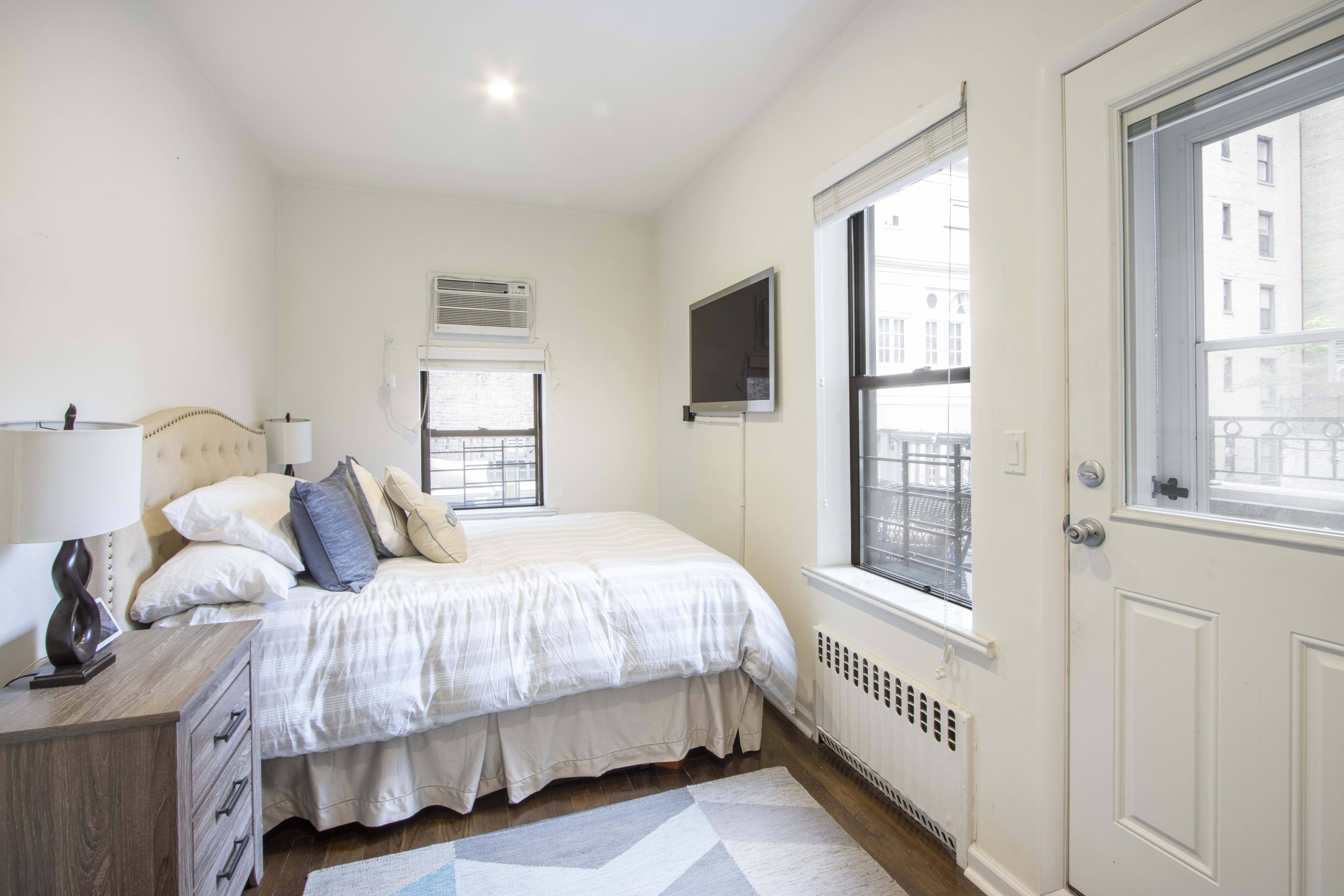 160 East 74th Street, Unit 3 Manhattan, NY 10021 - Photo 10 of 12 a bedroom with a bed next to a window