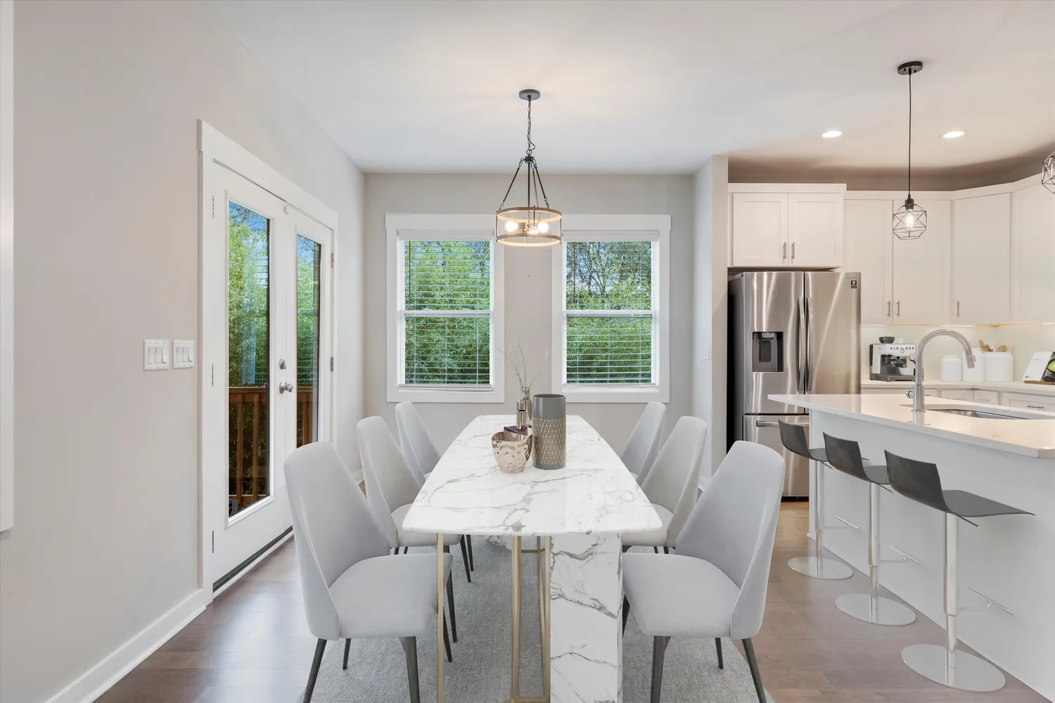 a dining room with furniture a chandelier and wooden floor