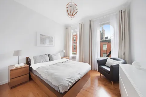 a spacious bedroom with a bed and a couch