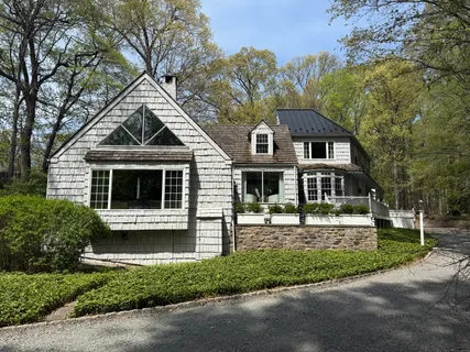 front view of a house with a tree