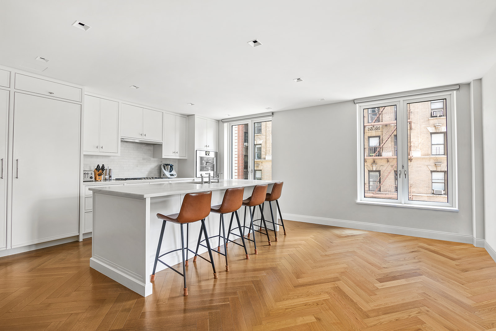 250 West 81st Street, Unit 4A Manhattan, NY 10024 - Photo 6 of 26 a kitchen with stainless steel appliances granite countertop a stove top oven a sink dishwasher and white cabinets with wooden floor