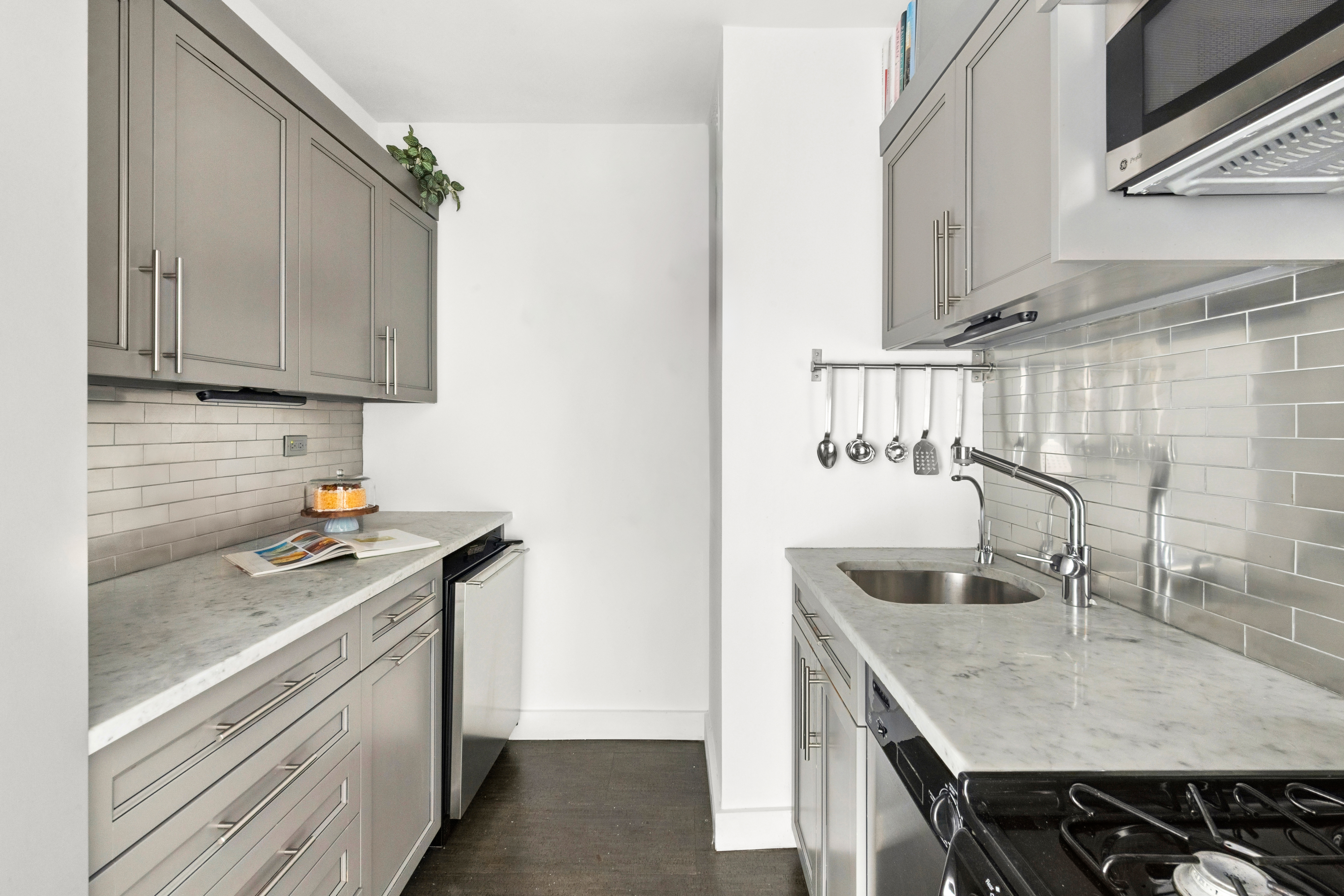 196 East 75th Street, Unit 16G Manhattan, NY 10021 - Photo 4 of 10 a kitchen with stainless steel appliances granite countertop a sink stove and cabinets