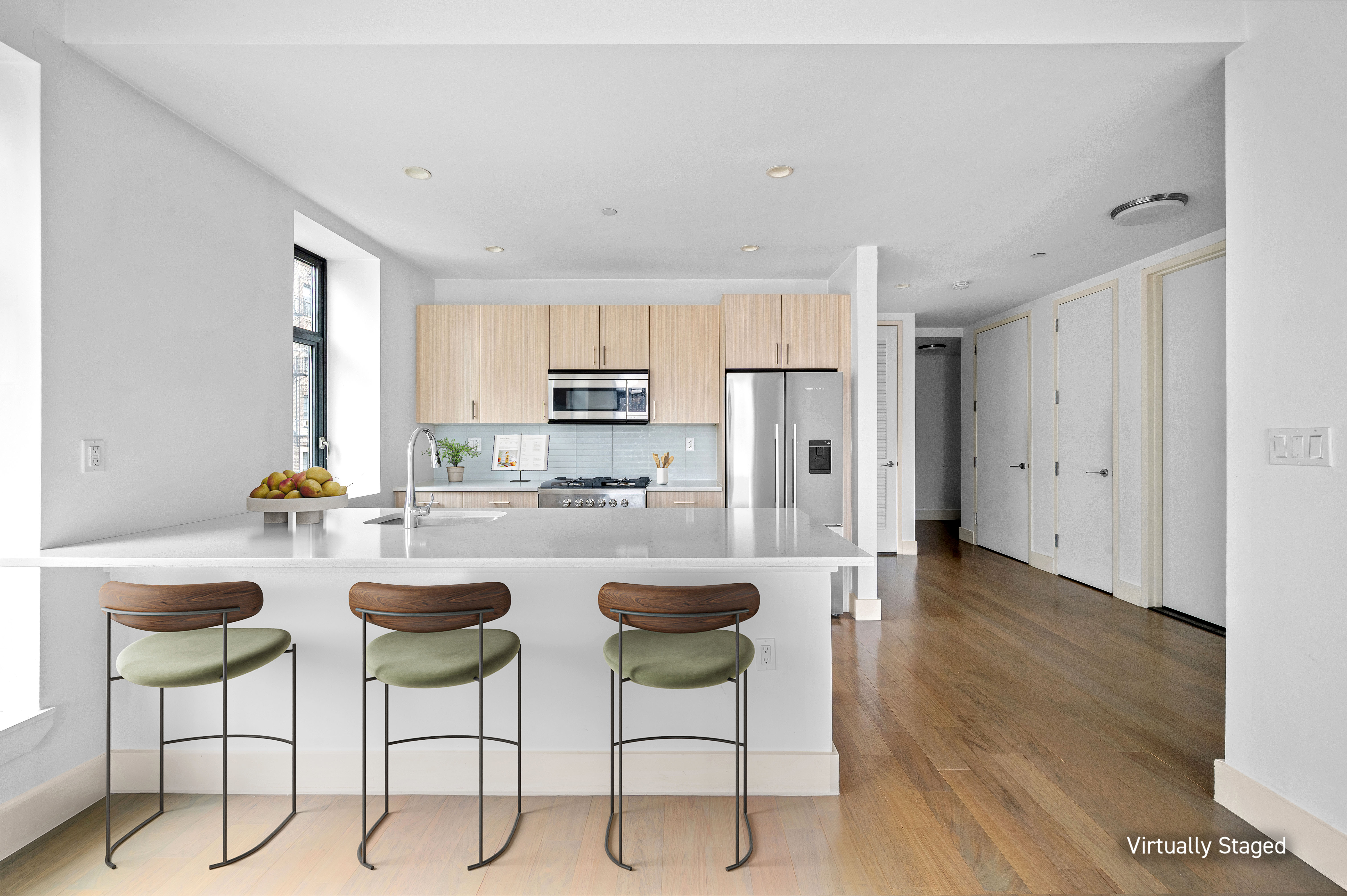 17 Convent Avenue Manhattan, NY 10027 - Photo 5 of 15 a kitchen with stainless steel appliances kitchen island granite countertop a dining table chairs and granite counter tops